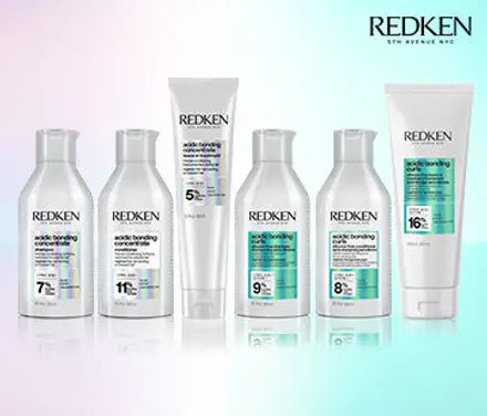 A six-piece Redken Acidic Bonding Kit arranged on a reflective surface against a pastel gradient background. The kit includes five white bottles and one white tube, ranging from 7% to 16% acid, with white caps.