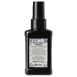 Black bottle of Davines hair product on a white background