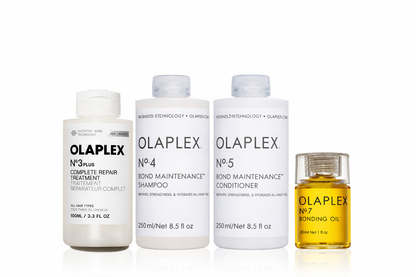 Olaplex No.3 Plus Complete Repair Treatment, No.4 Bond Maintenance Shampoo, No.5 Conditioner, and No.7 Bonding Oil haircare set on white background